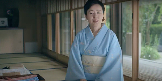 Still image from the video. A woman wearing a kimono in a traditional Japanese room.
