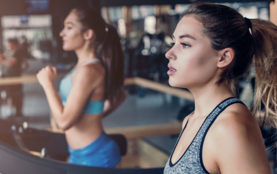 An image of a woman sweating while on the treadmill.