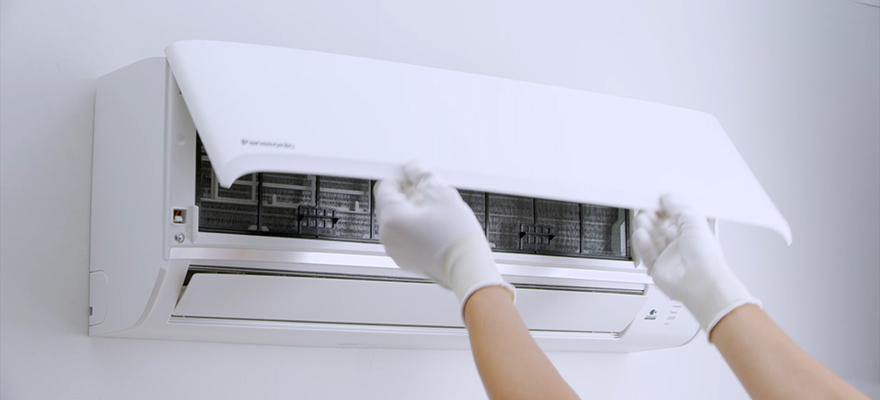 A photo of a person opening an air conditioner