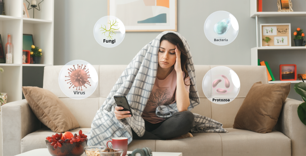 Women sick on couch with bubbles showing the types of germs.