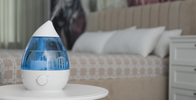 A blue humidifier near the bed