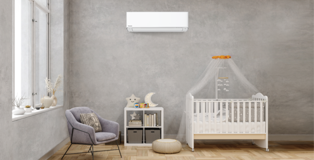 Panasonic air conditioner inside a baby room beside a baby's bed