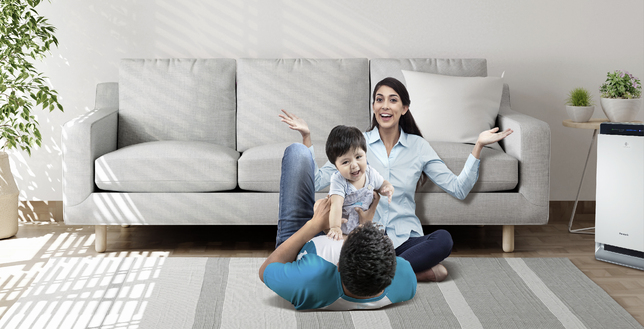 Family spending time in a living room featuring Panasonic air purifier