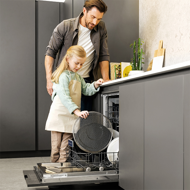 Dad and daughter adding the air frying basket into the dishwasher