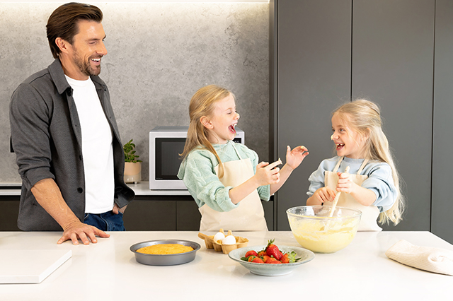 Kids having fun baking a cake