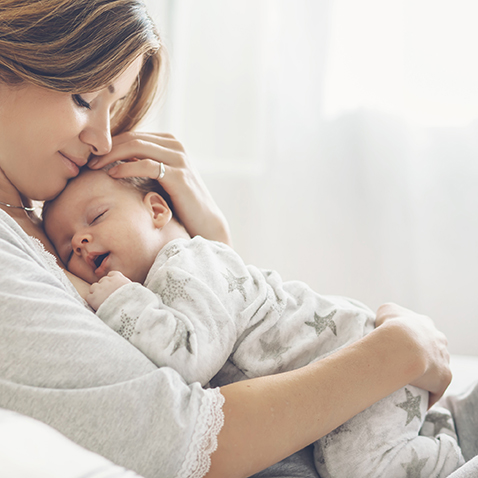 Image of mother taking care of a baby