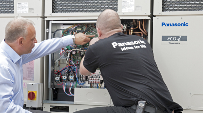 An image of workers installing Panasonic outdoor units
