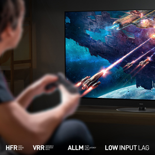 Young man playing a video game on the Panasonic JZ1000 tv