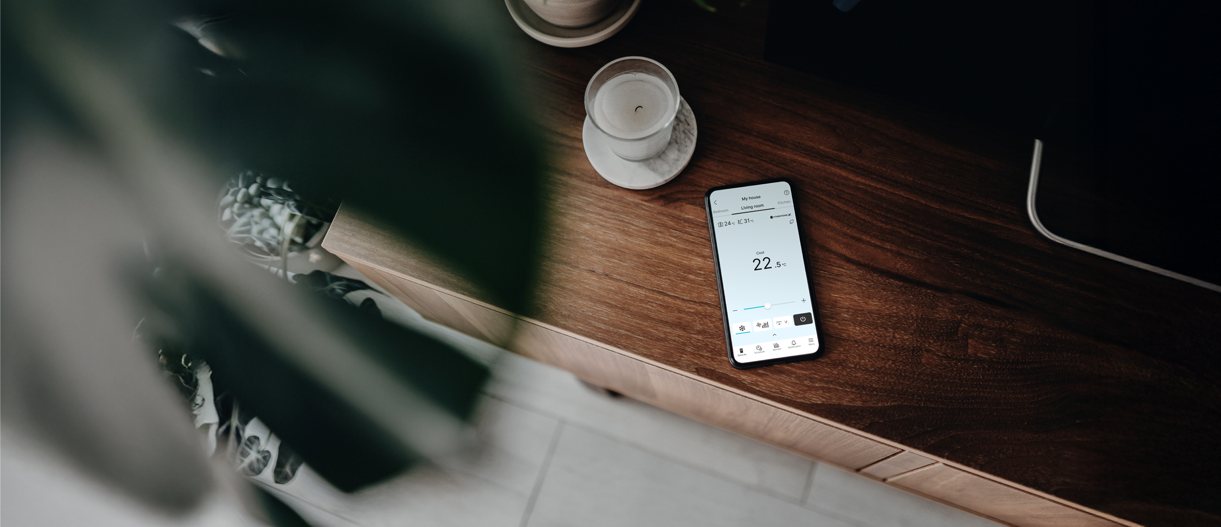 An image of using Panasonic Comfort Cloud App on a smartphone to control various air conditioners in different locations