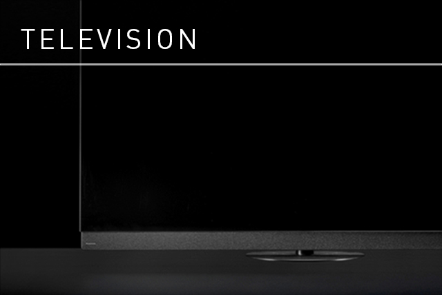 Link Banner: Television. Dramatic black and white close-up image of a TV, subtle highlights giving it form against the dark background.