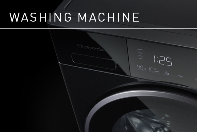 Link Banner: Washing Machine. Dramatic black and white close-up image of a washing machine, subtle highlights giving it form against the dark background.