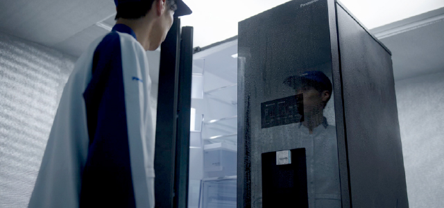 Panasonic worker conducting tests on a refrigerator.
