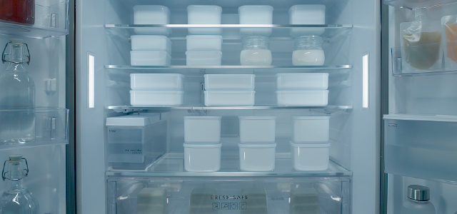 View inside a refrigerator filled with various unlabeled containers for testing temperature control.