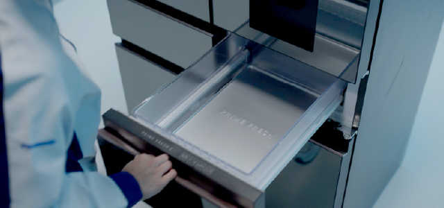Panasonic worker opening a refrigerator drawer during testing.
