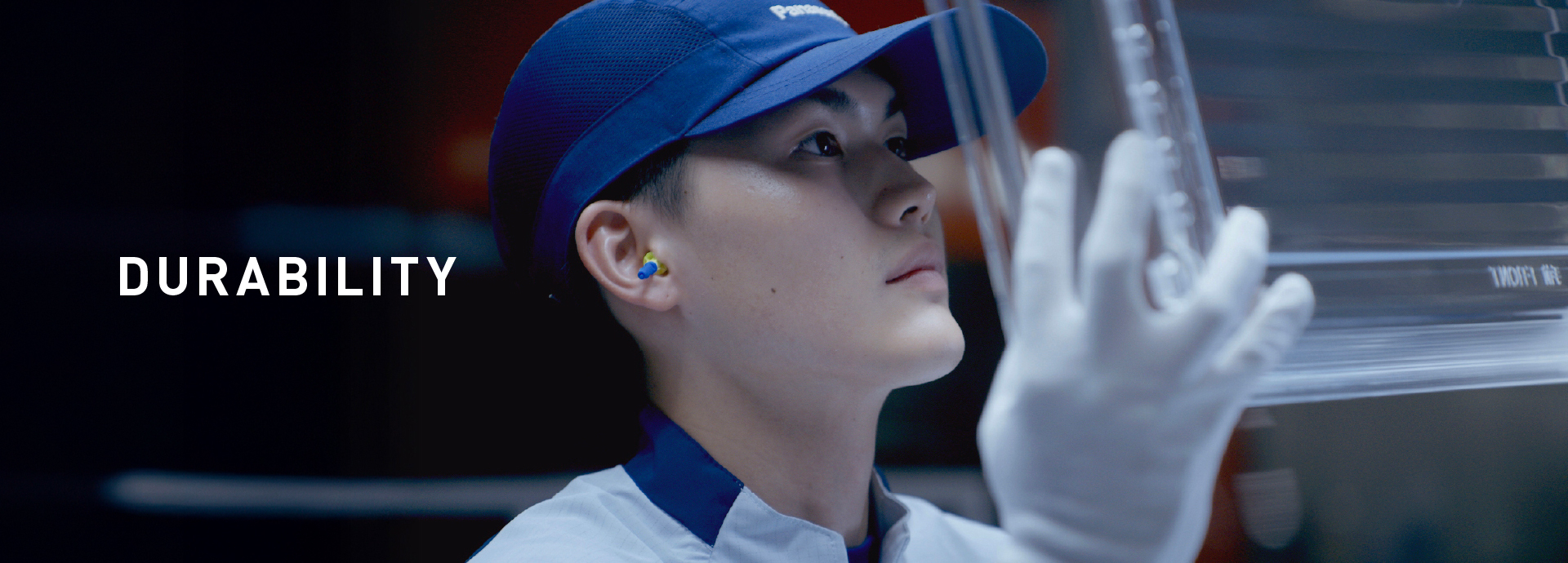 DURABILITY. Panasonic worker closely inspecting interior refrigerator shelves.
