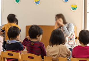 An image of playing kids with a teacher