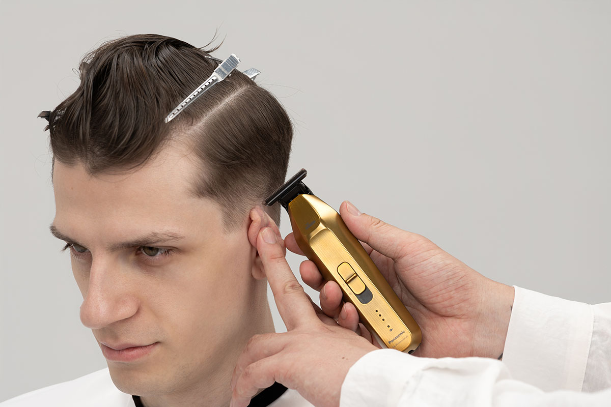 In Use around the Ear with a Hair Trimmer ER-XT70