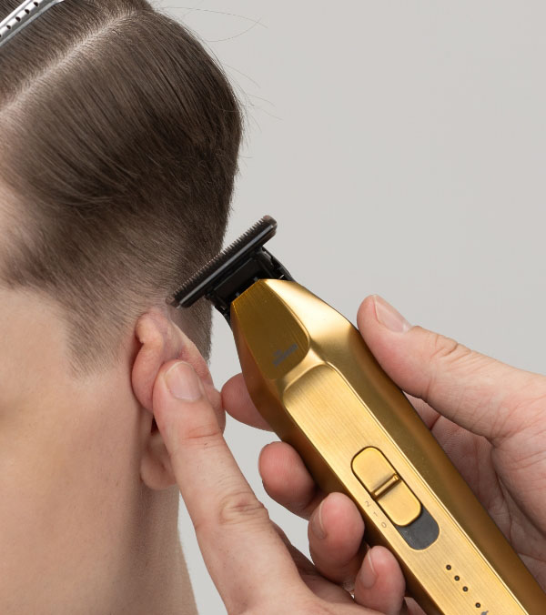 In Use around the Ear with a Hair Trimmer ER-XT70