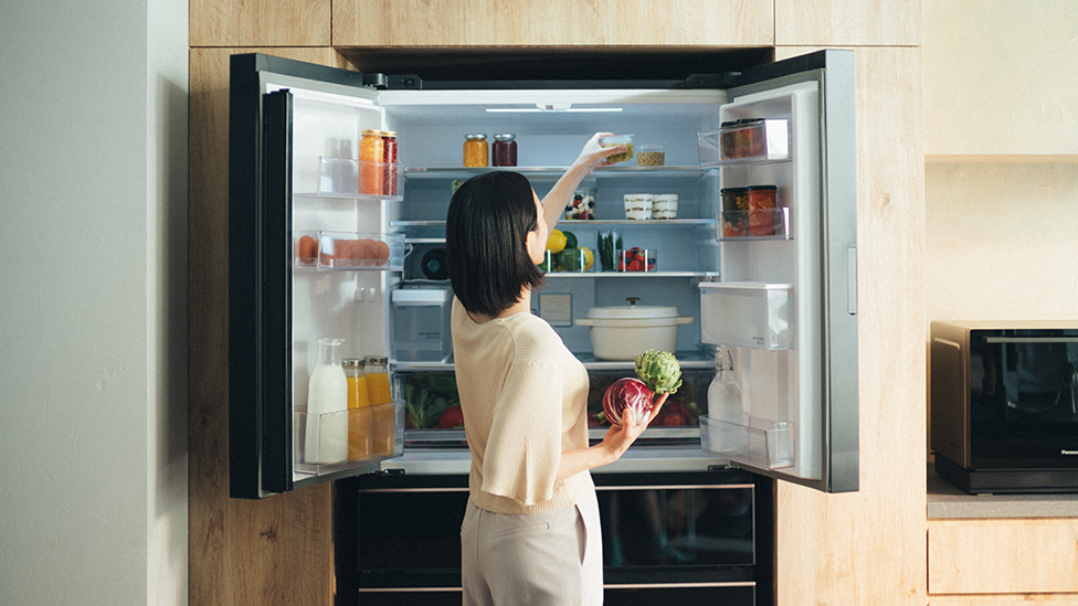 Image of mother taking food out of the refrigerator