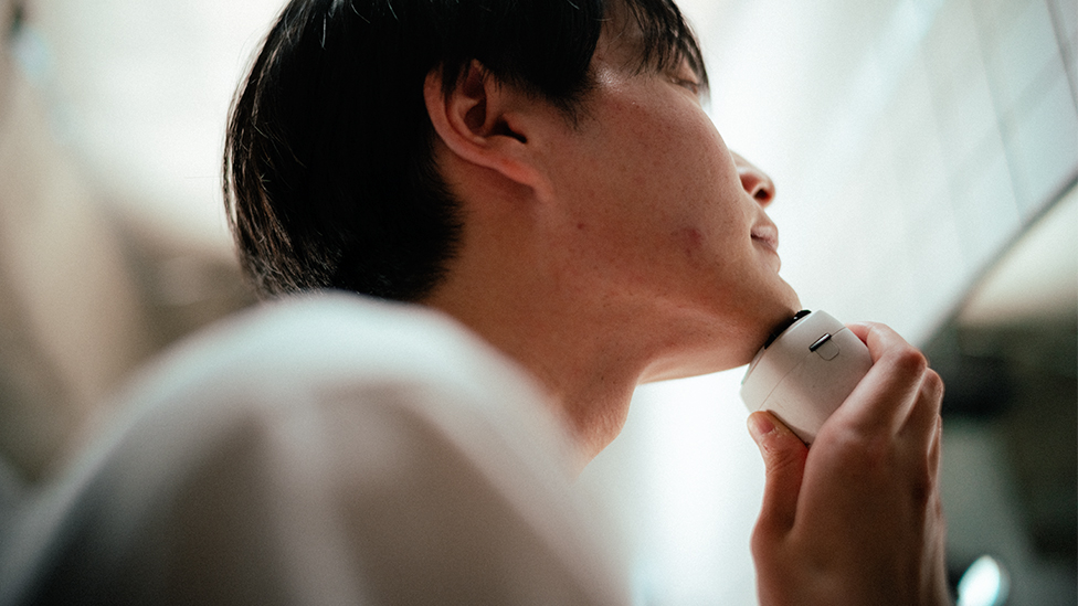 Image of man shaving his beards