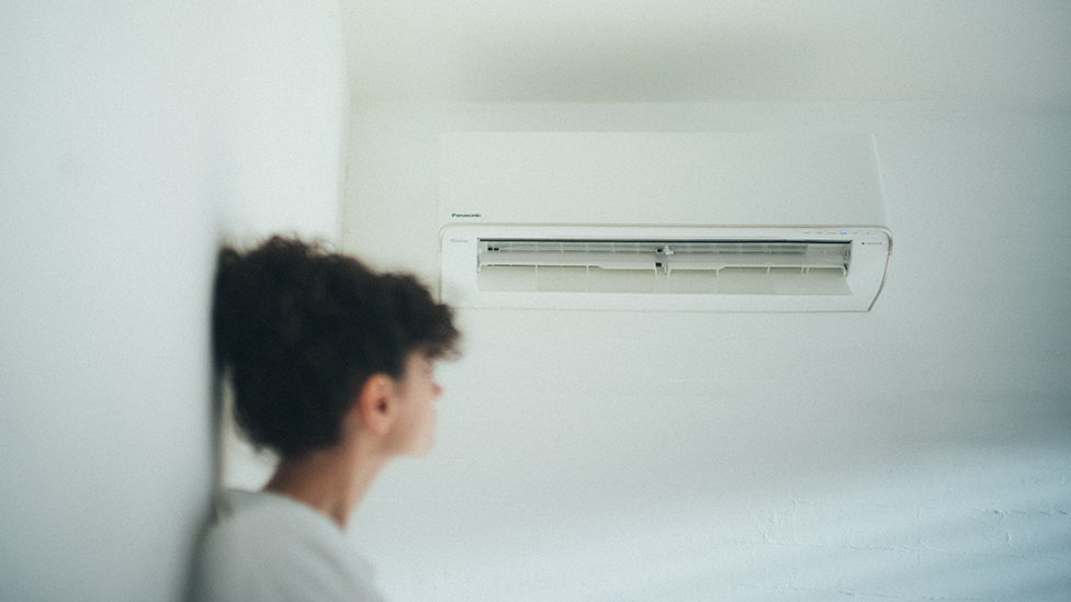 Image of woman with a nice breeze from the air conditioner