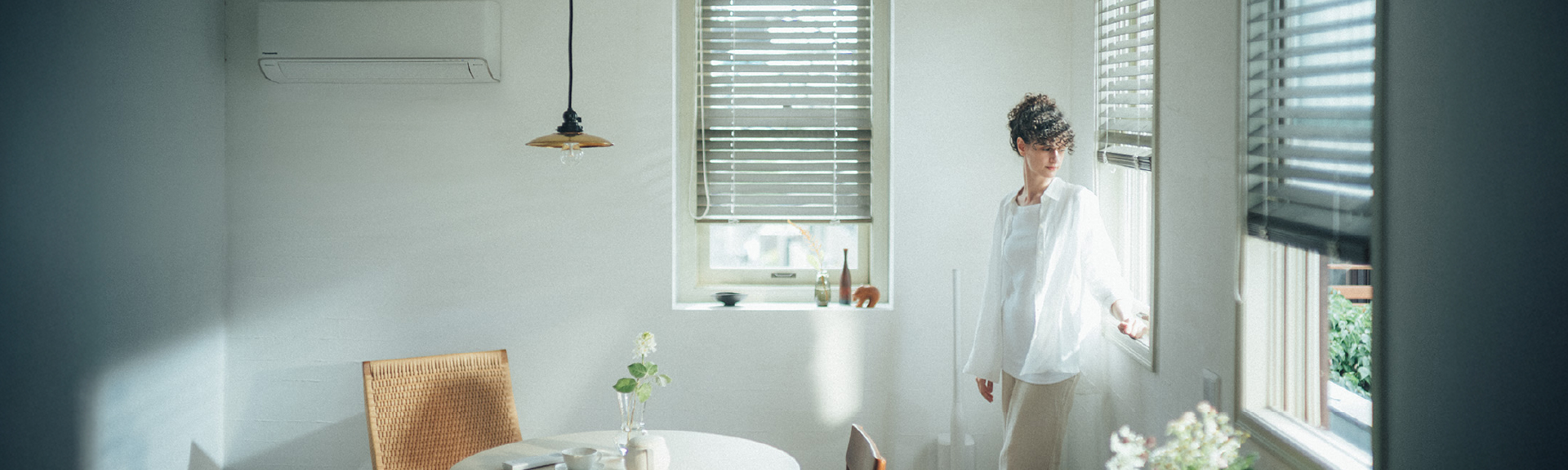 Top Banner: A woman relaxing in an airy, comfortable room with a wall-mounted AC unit.
