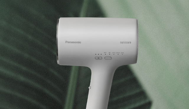 Image of a compact light grey hair dryer.