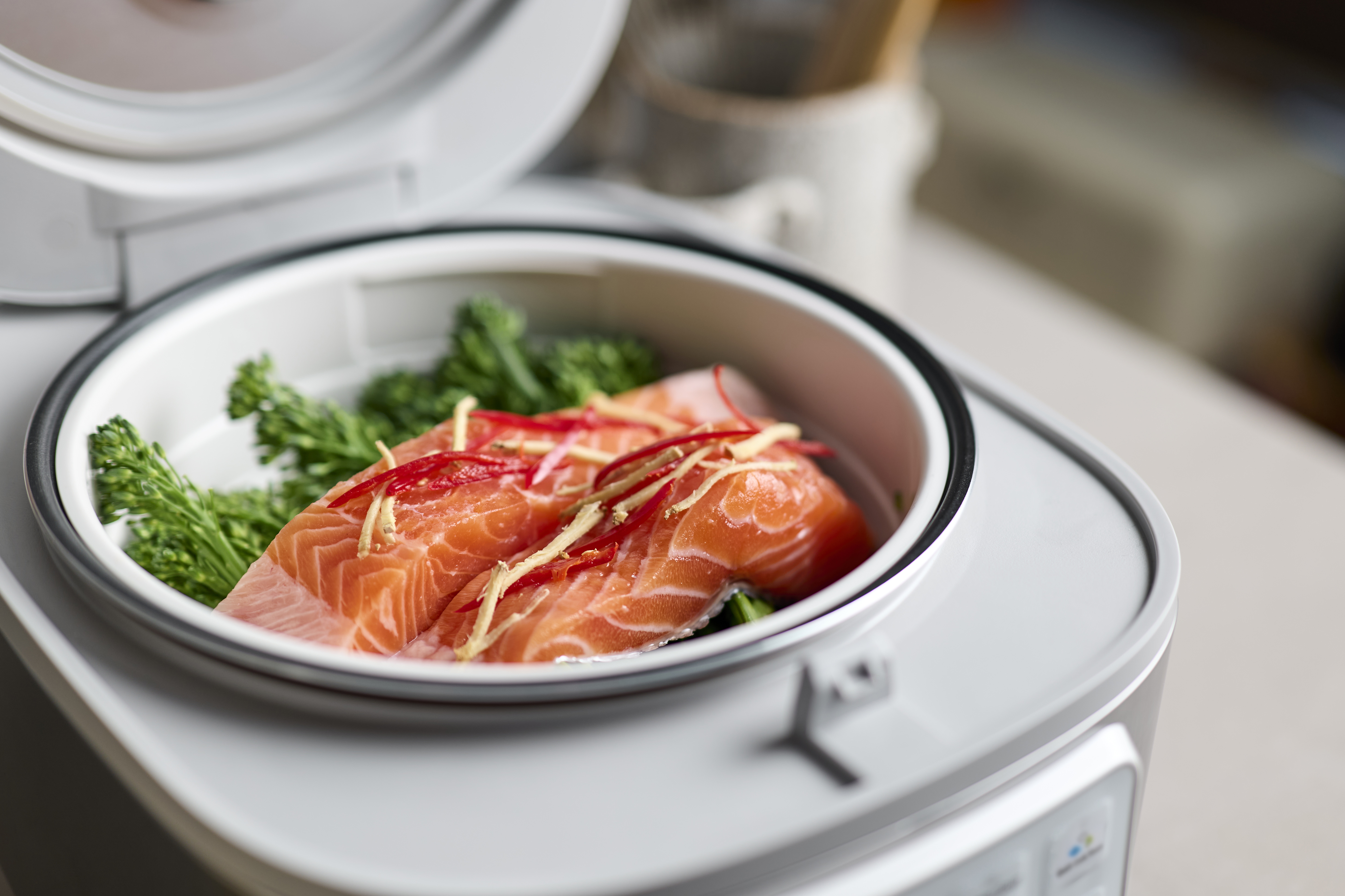 Close-up view inside the SR-DA152WXE Rice Cooker in White showing salmon with vegetables and spices.