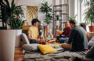 Group of people raising glass in living room