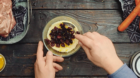 Roast lamb stuffed with lemon-couscous on glazed carrots