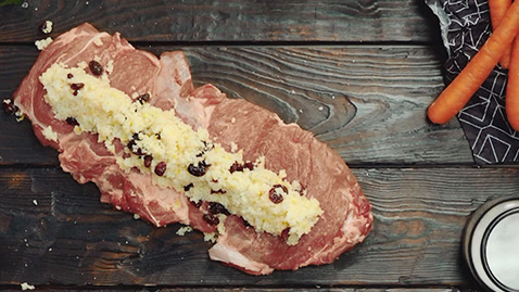 Roast lamb stuffed with lemon-couscous on glazed carrots