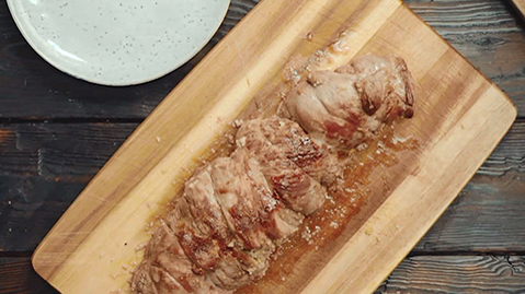 Roast lamb stuffed with lemon-couscous on glazed carrots