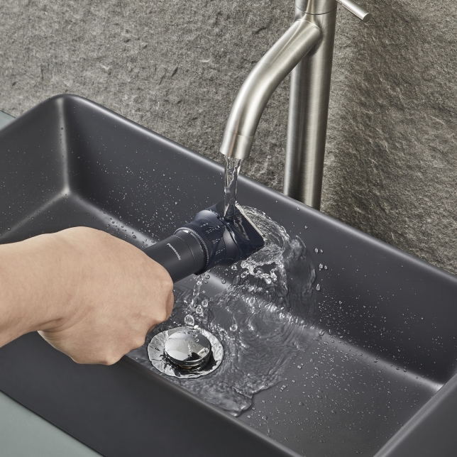 Hand rinsing Multishape under running water in a sink