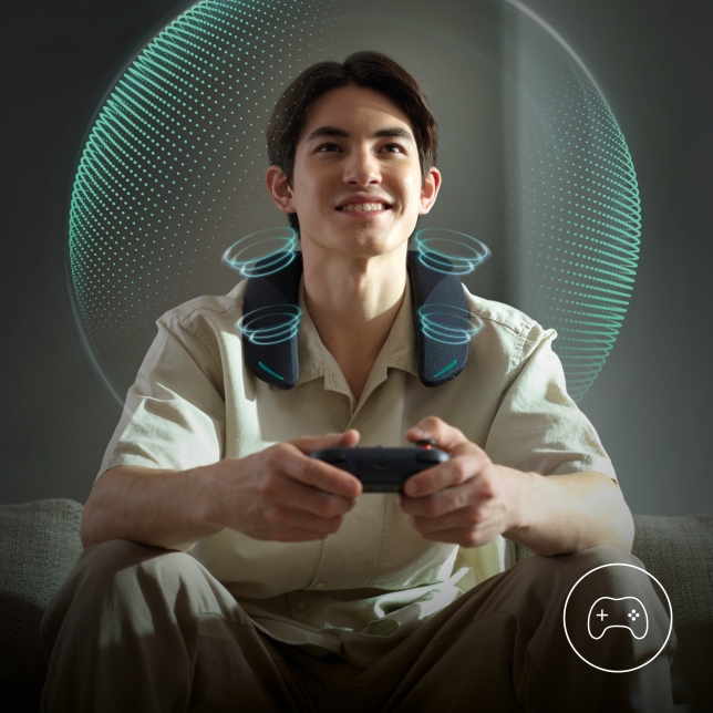 Gamer wearing SC-GNW30 neck speaker with teal LED lights, indicating active voice mode.