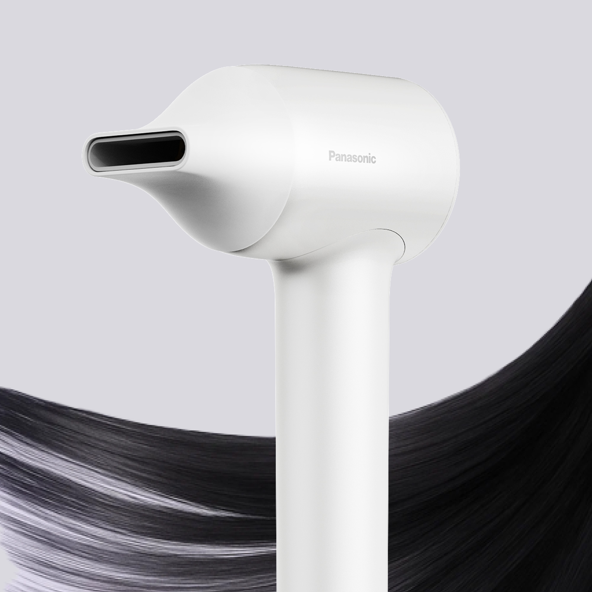 Close-up of the cream-colored Panasonic hair dryer with the concentrator nozzle attached