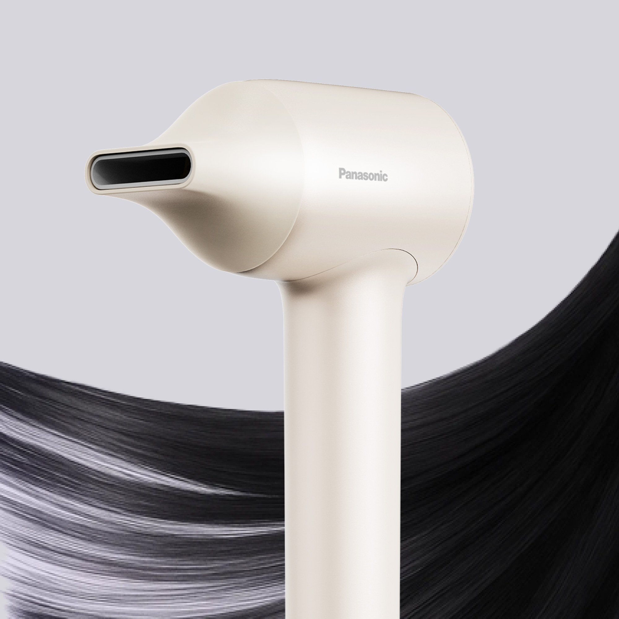 Close-up of the cream-colored Panasonic hair dryer with the concentrator nozzle attached