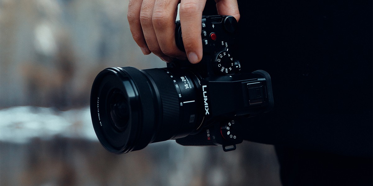 A creator casually carrying the LUMIX S5II in one hand