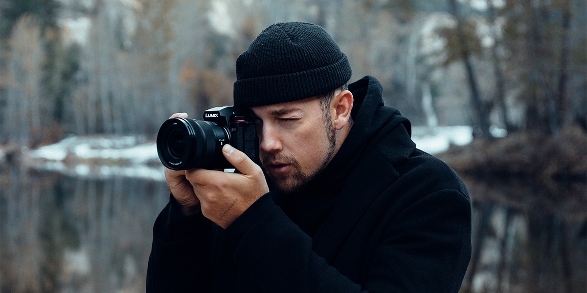 A creator framing a shot through the viewfinder