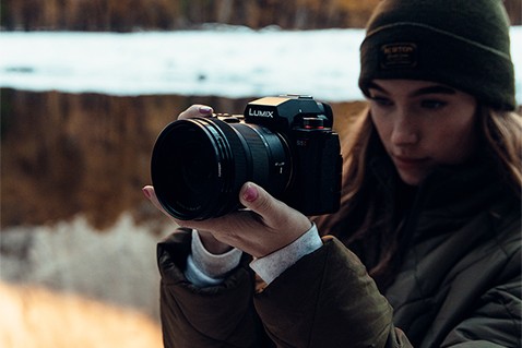 A creator shooting handheld with the LUMIX S5II