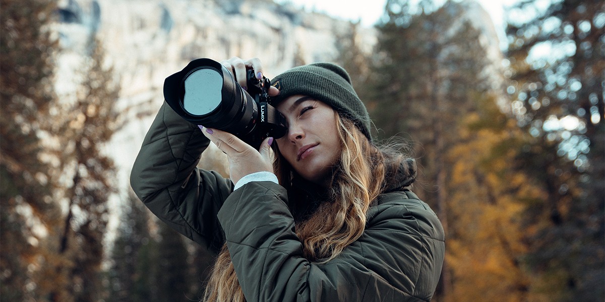 A creator framing a shot through the viewfinder