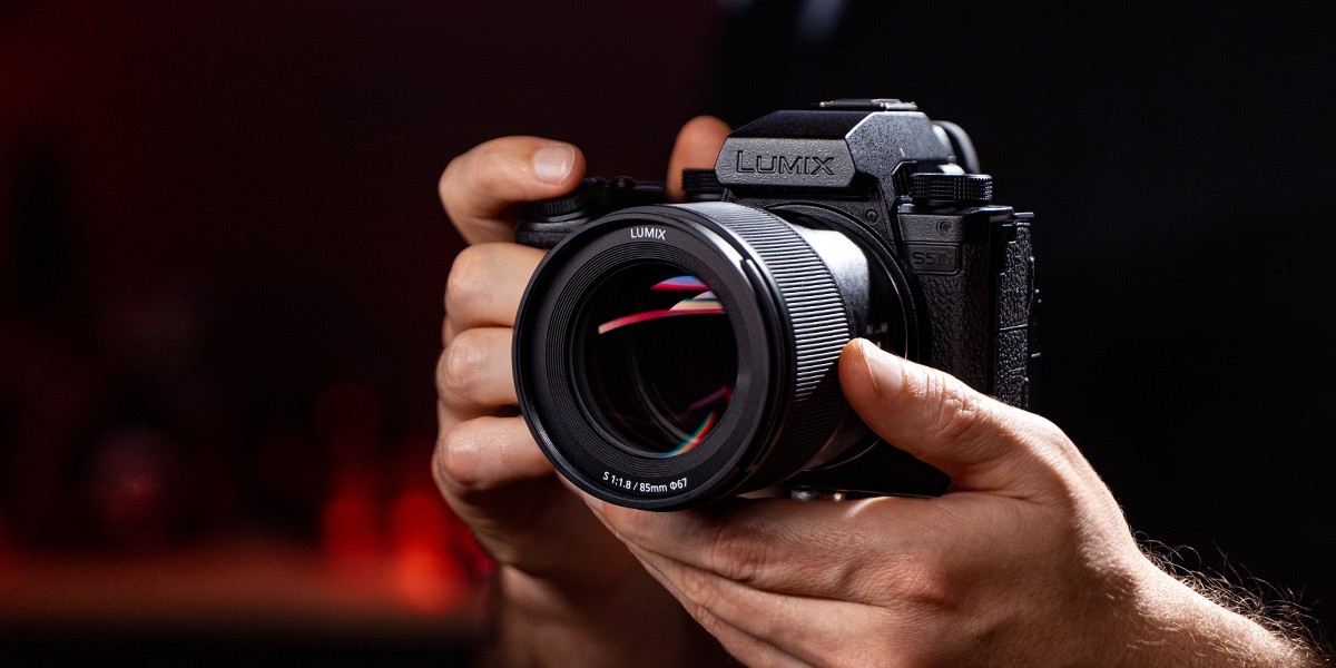 A content creator holding the LUMIX S5IIX ready to shoot