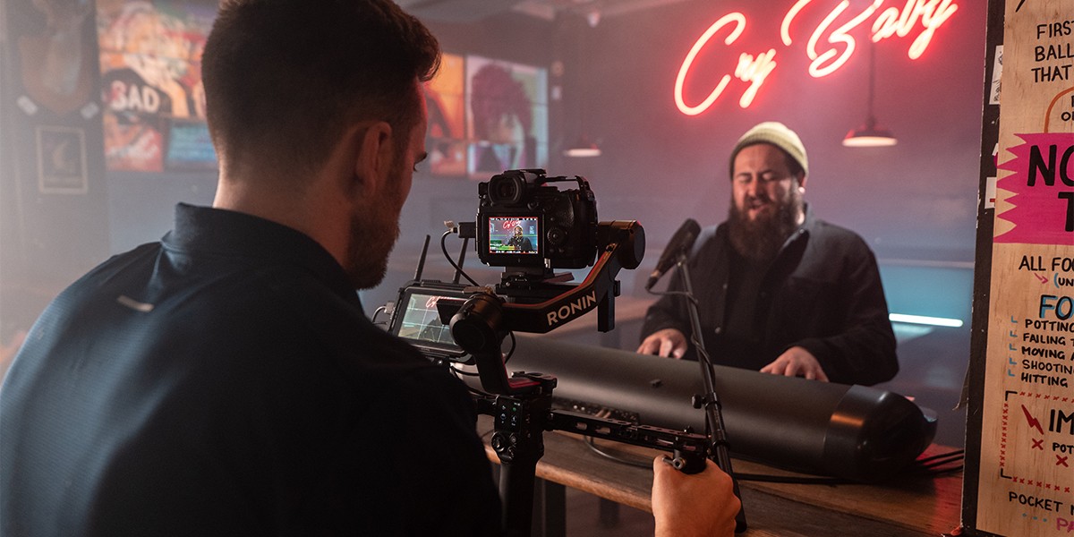 A content creator filming a video with the LUMIX S5IIX