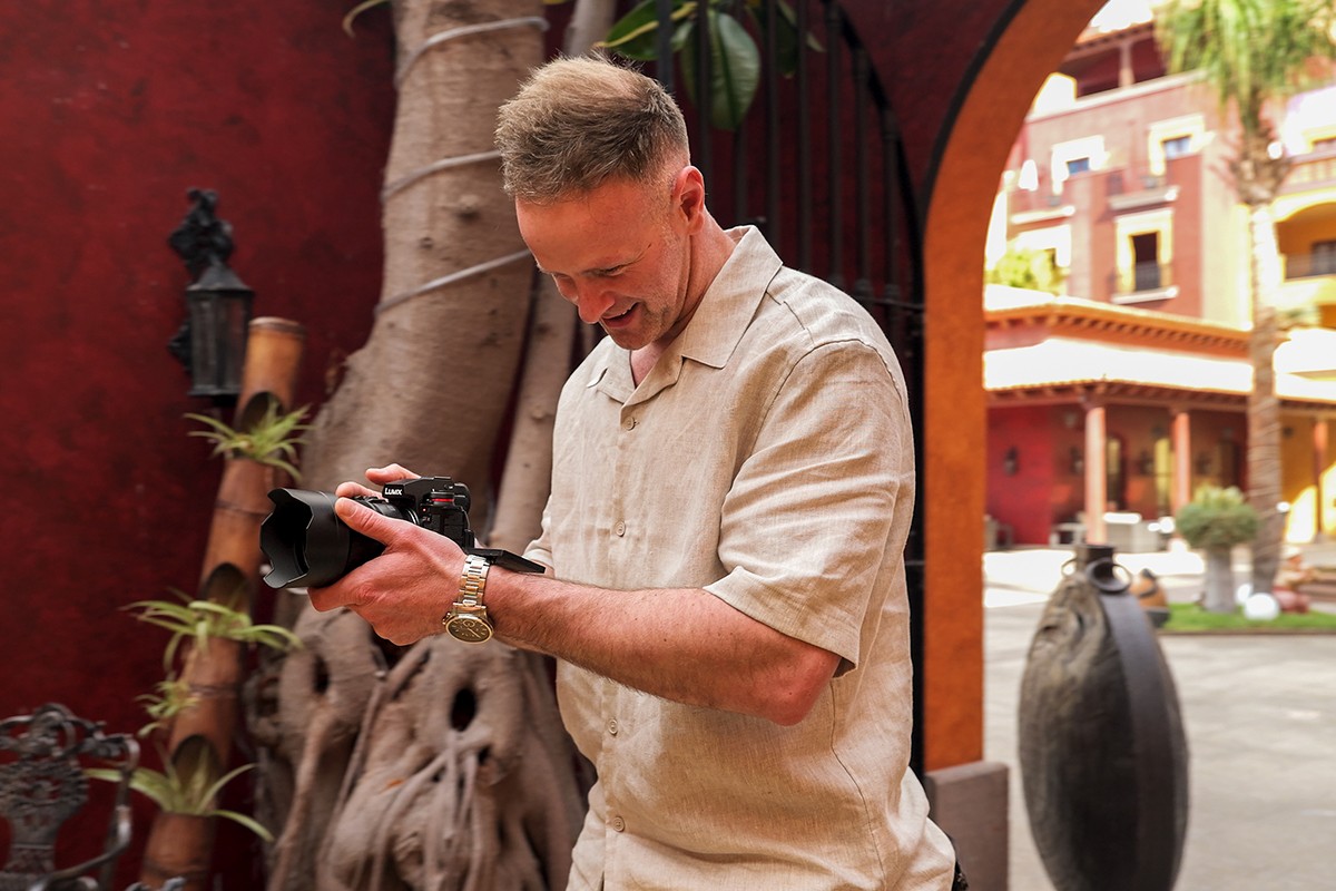 A content creator filming a video with the LUMIX S1IIE